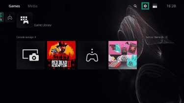 PlayStation 5 home screen. The "Settings" icon is highlighted.